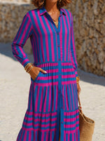 Women's Vibrant pink & blue vertical stripe shirt dress with collared neck and full button front. Elastic waist tiered ruffle skirt, front slit and side pockets. Light flowy fabric, eye-catching resort wear for beach and summer daily outfits.